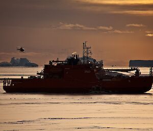 A helicopter takes off from Aurora Australis during refuelling operations at Australia’s Davis station