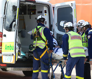 The patient is transferred into the ambulance