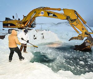 Expeditioners and digger working on the swimming hole