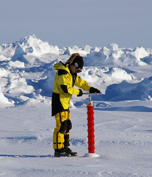 Scientist drilling ice core in Antarctica