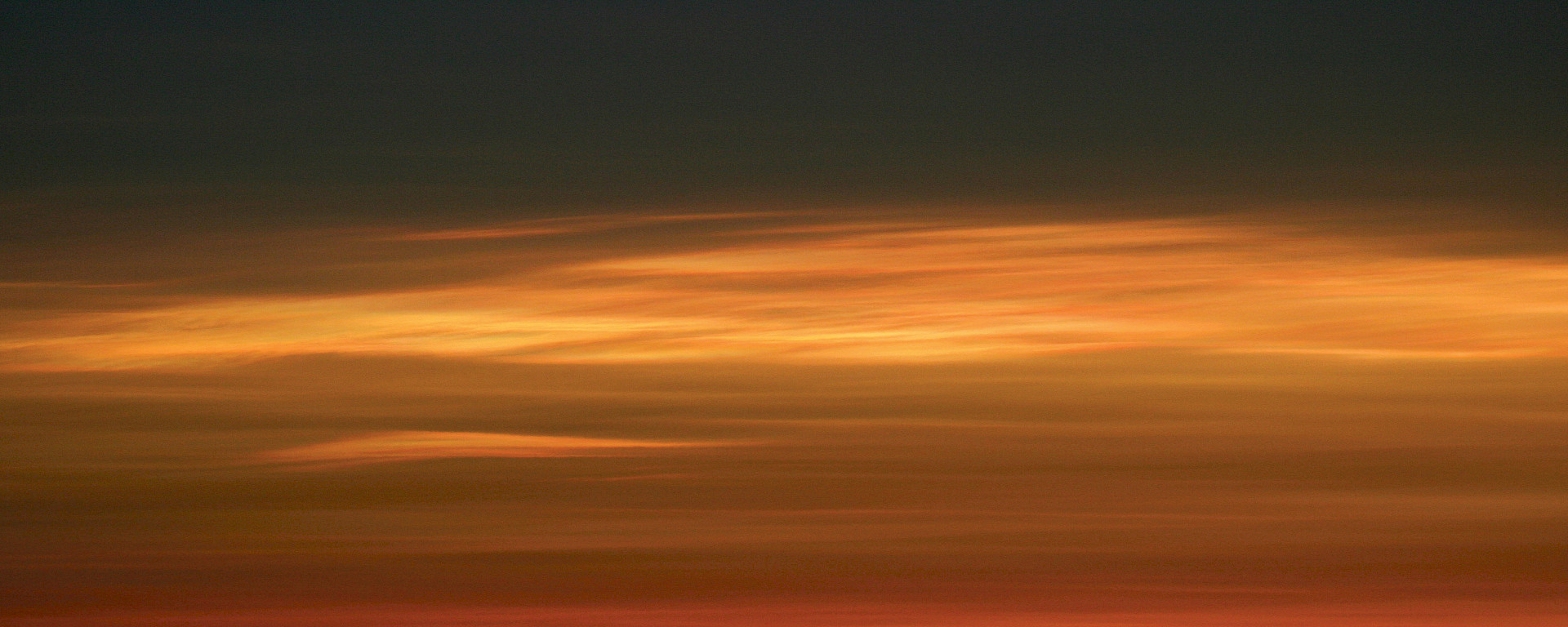 Stratospheric clouds, seen here illuminated by the sun during twilight