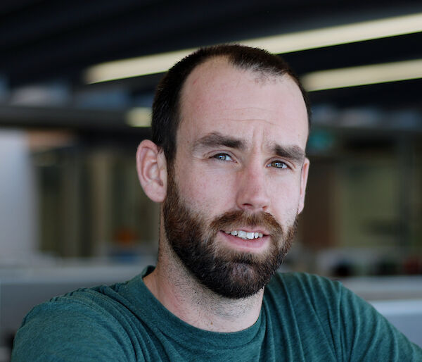 Dr Rowan Trebilco portrait — a man with short beard who is between age 25–35.