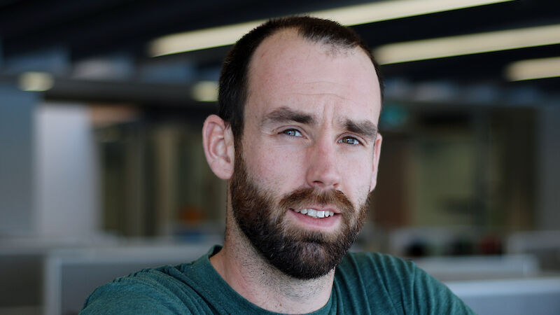 Dr Rowan Trebilco portrait — a man with short beard who is between age 25–35.