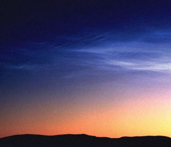 Noctilucent clouds in the Southern Hemisphere are dimmer, less frequent and higher than those in the Northern Hemisphere