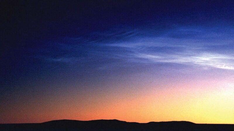 Noctilucent clouds in the Southern Hemisphere are dimmer, less frequent and higher than those in the Northern Hemisphere