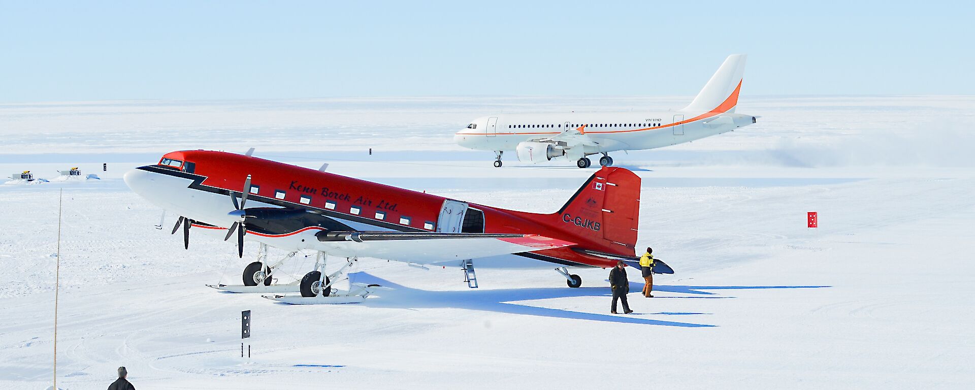 A Basler aircraft in the foreground, with A319 aircraft in the background