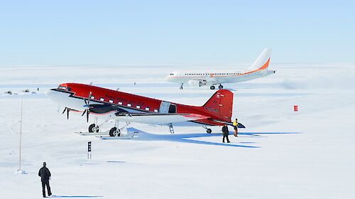 A Basler aircraft in the foreground, with A319 aircraft in the background