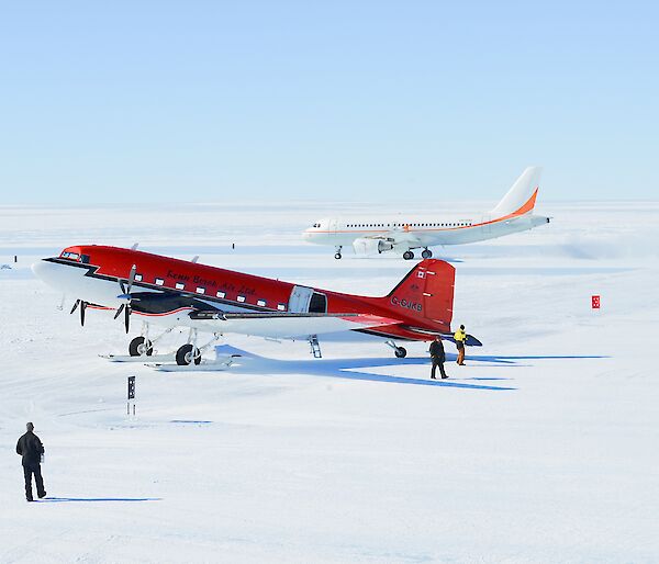 A Basler aircraft in the foreground, with A319 aircraft in the background