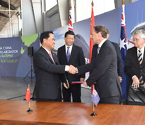 Administrator of the State Oceanic Administration of the People’s Republic of China Mr Liu Cigui and Environment Minister Greg Hunt shake hands after signing a Memorandum of Understanding