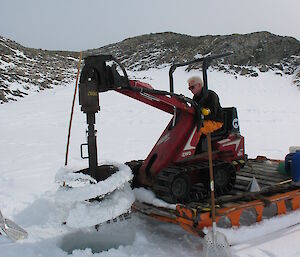 Digging a hole through the sea ice in O'Brien Bay