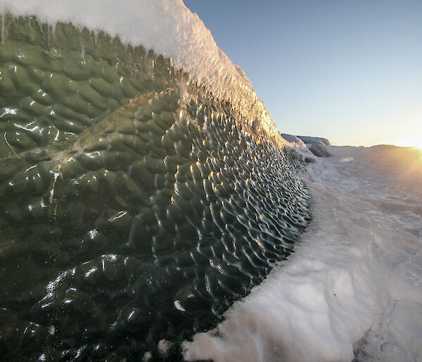 Sunlight glistens of an Antarctic iceberg