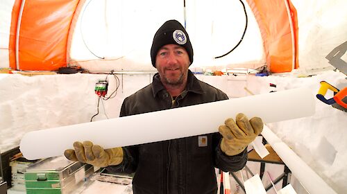 Dr Mark Curran holds up a one-metre length of ice core.