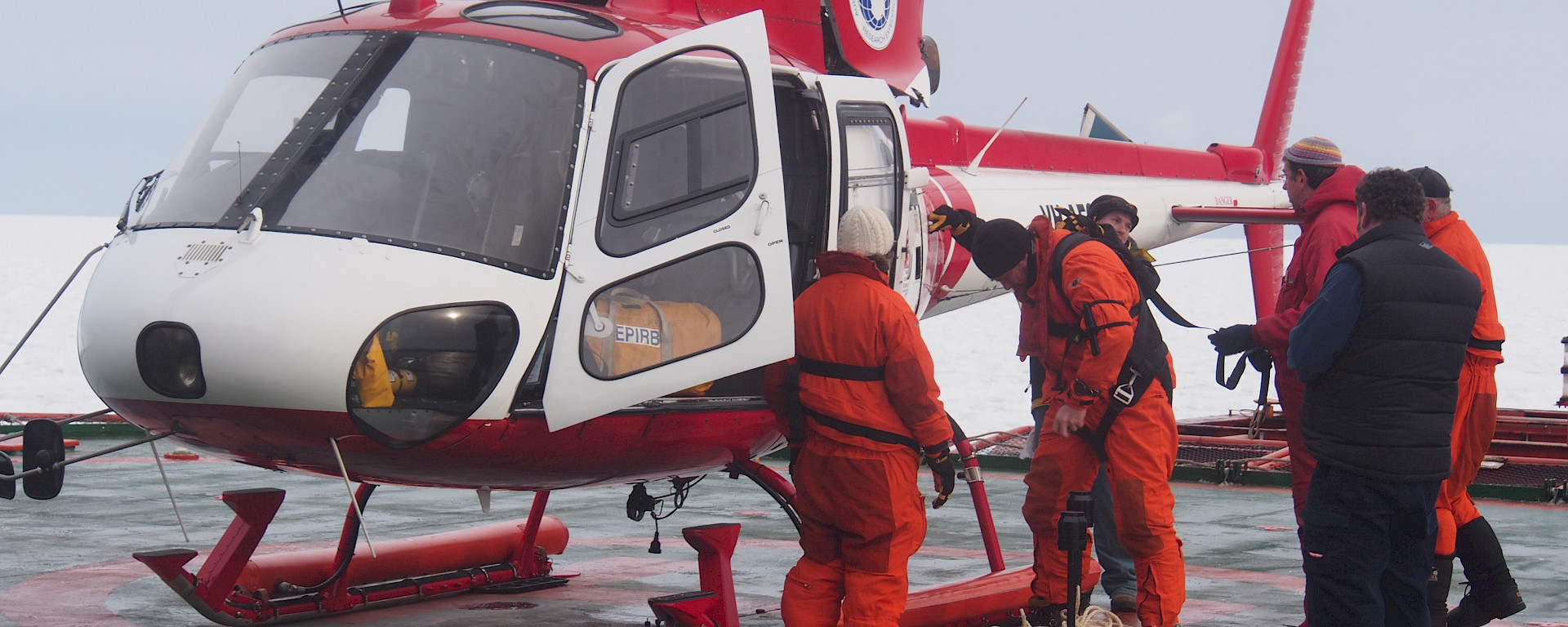 Dr Alison Kohout (left) prepares to deploy wave sensors on ice floes deep in the Marginal Ice Zone, accessible only by helicopter.