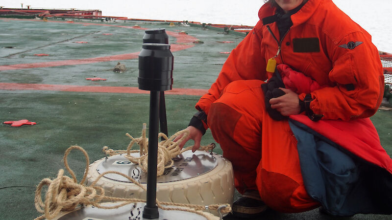 Dr Alison Kohout with two of her wave sensors on the stern of the Aurora Australis during the Sea Ice Physics and Ecosystem eXperiment (SIPEX-II) voyage in September 2012.