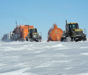 Tractors in a traverse train heading for Aurora Basin.