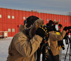 Casey expeditioners prepare their cameras ready for the solar eclipse