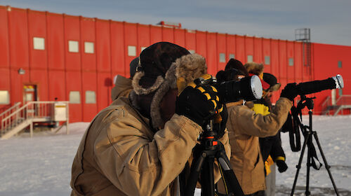 Casey expeditioners prepare their cameras ready for the solar eclipse