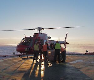 Loading a helicopter on the deck of the Aurora Australis