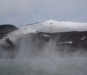 Steam rises off volcanically-warmed water near Deception Island.