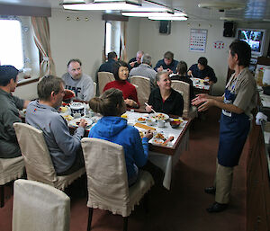 A group of scientists from many countries enjoy a meal in the mess of the Umitaka Maru