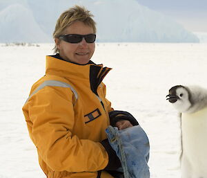 Dr Barbara Wienecke with an emperor penguin chick.