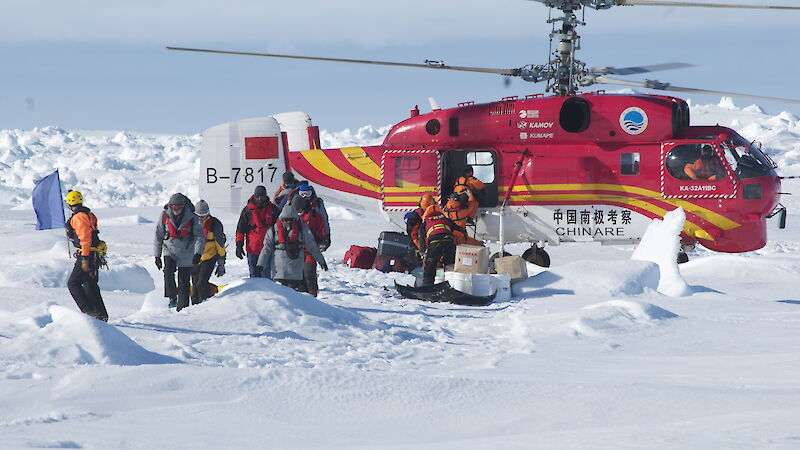 Passengers disembarking from helicopter