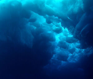 This under ice view shows the thick, jumbled structure of ice under an ice floe, which makes it very hard to dig holes through to the ocean surface. (Photo: ROV team)