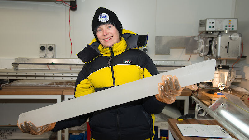 Dr Tessa Vance with an ice core from Aurora Basin in the new ice core facility at IMAS.