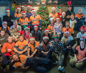 Davis station expeditioners in front of their Christmas tree