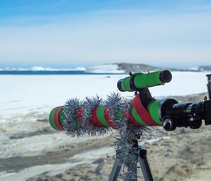 A festive telescope looks out over the icebergs near Davis station