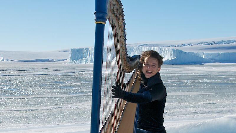 Harpist Alice Giles playing her harp on the sea ice