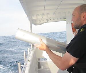 Marine mammal acoustician Dr Brian Miller deploying a sonobuoy