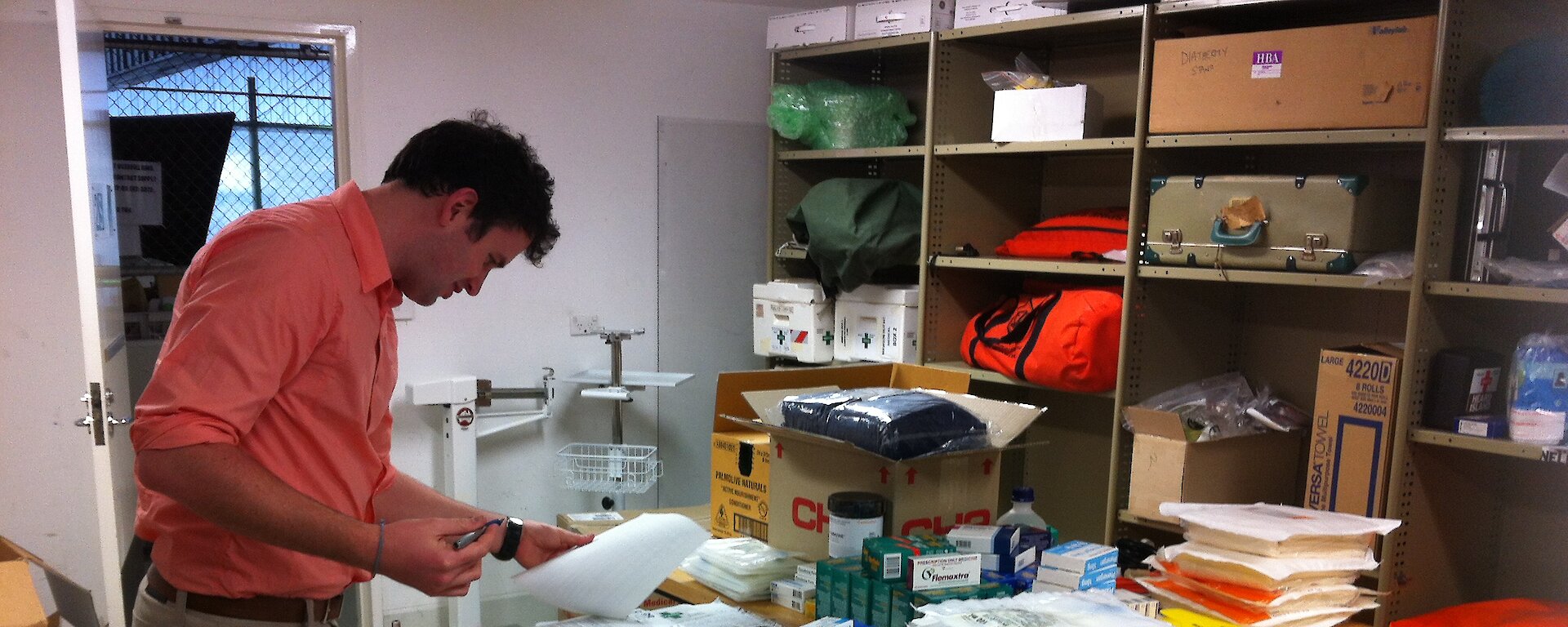 Medical student John Cherry sorting through medical supplies for Australia’s Antarctic stations at head office in Kingston.