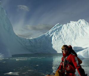 Scott next to water with an iceberg in the background