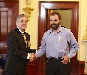 His Excellency Rear Admiral Kevin Scarce with Dr James Doube wearing his Antarctic Medal