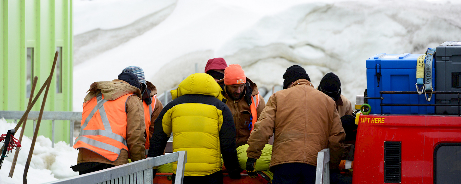 Expeditioners at Davis station assist their injured colleague