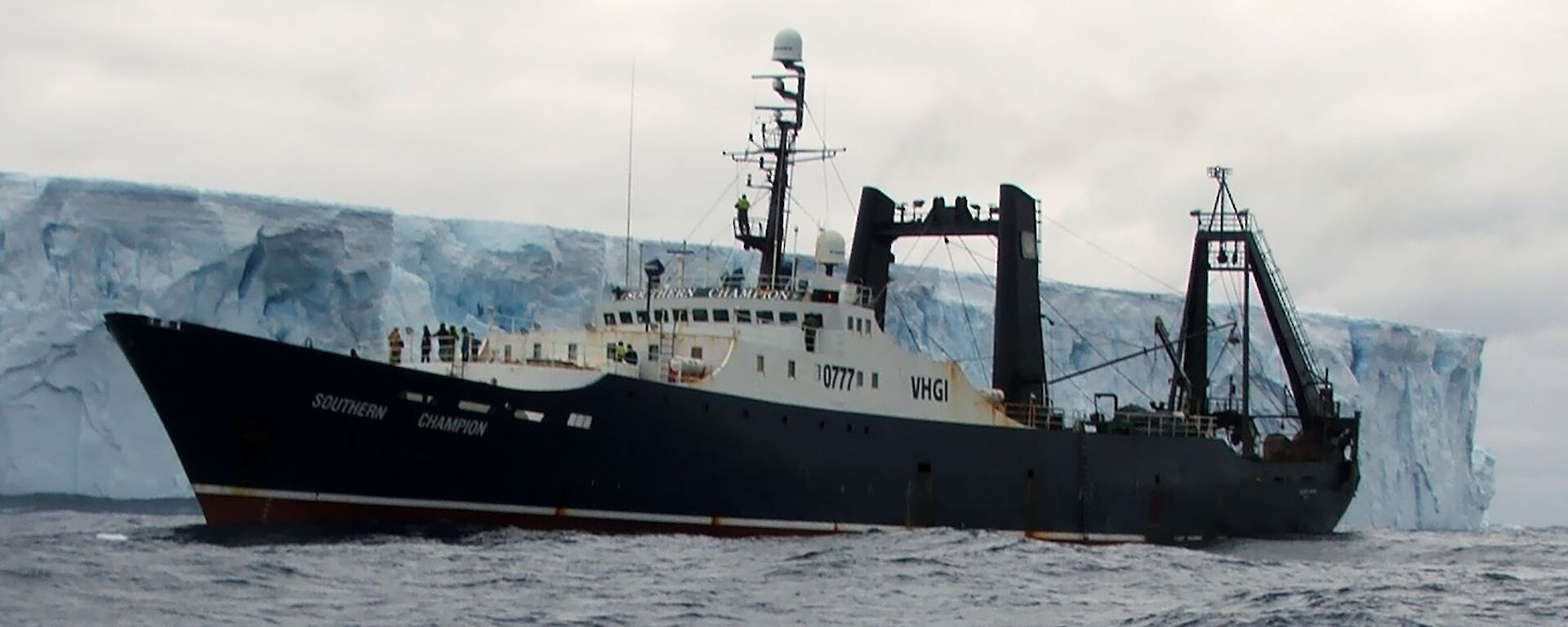 The Patagonian toothfish vessel, Southern Champion, alongside an iceberg in Antarctica.