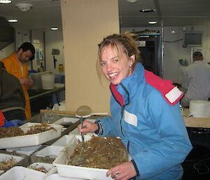 Helena sorting through a catch in the wet lab of the ship Aurora Australis