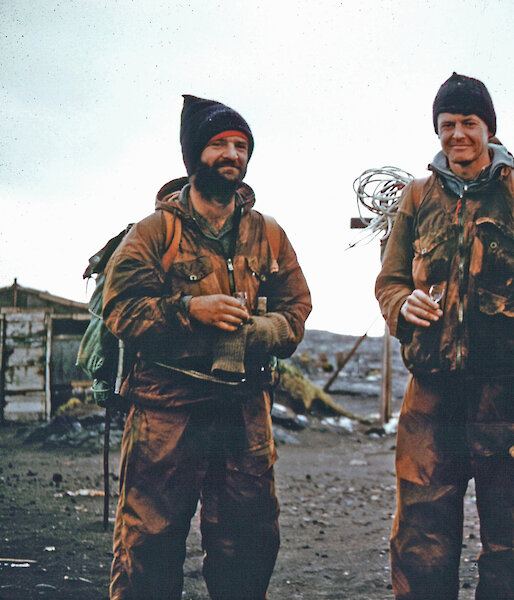 The Mountain Party share a tot of whisky on arriving at the ANARE Station, Heard Island, after their retreat from the summit plateau of Big Ben.