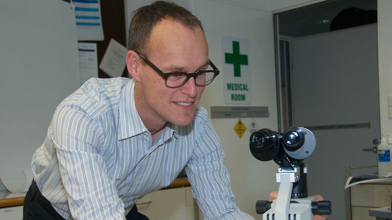 Dr Graham Denyer with microscope