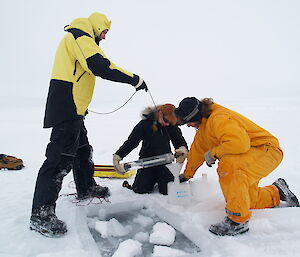 Scientists collecting water samples from under the sea ice on the first SIPEX voyage in 2007