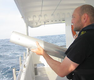 Marine mammal acoustician, Dr Brian Miller, deploying sonobuoy