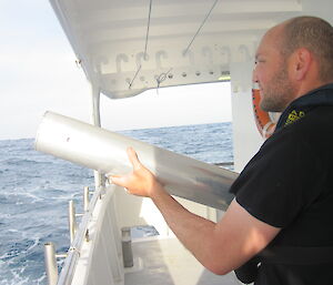 Marine mammal acoustician, Dr Brian Miller, deploying sonobuoy