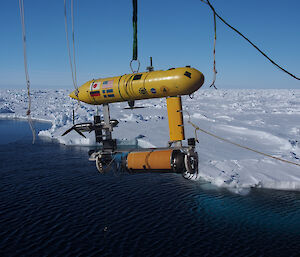 The AUV being lowered off the stern of the ship. The data from the robot will be used to make 3-D maps of the underside of the sea ice (Photo: Wendy Pyper)