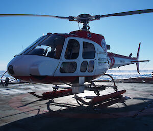 The instrumented helicopter carries a laser scanner, pyrometer and inertial navigation system within the housing to the right of the helicopter nose, a snow radar across the rear of the skids, a digital camera in the silver bucket underneath and a microwave radiometer in the ‘boot’ of the aircraft. GPS antennae are above the front windows