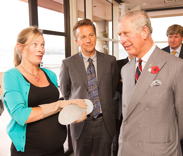 Dr Vance holding an ice core – the Prince of Wales and Dr Gales watching on