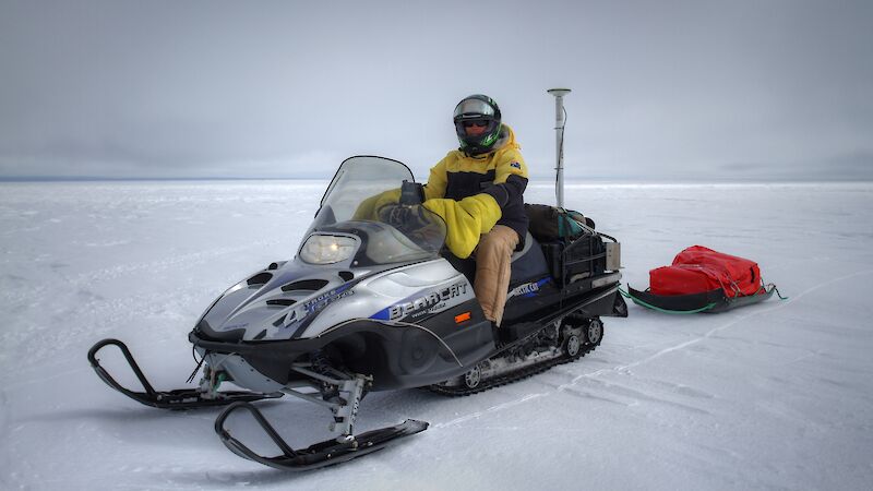 University of Tasmania scientist Dr Reed Burgette on a skidoo equipped with Global Positioning System equipment to obtain high resolution in situ estimates of surface topography, required to validate airborne and satellite data.