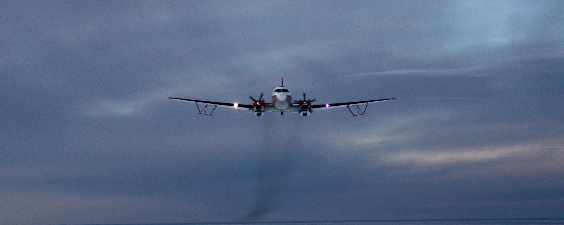 The Basler BT-67 aircraft with wing-mounted ice penetrating radar antennae.