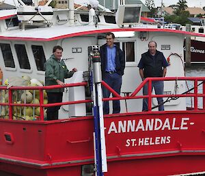 The Underwater Bait Setter on the stern of a fishing boat with engineers (left to right) Ian Carlyle, Phil Ashworth and Peter Ashworth