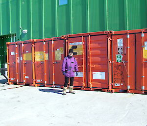 Expeditioner standing in front of containers